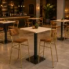 Ensemble mange-debout restaurant chêne clair 70x70 avec 2 tabourets simili cuir dans un bar